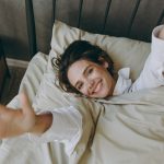 Young,Woman,Wears,Casual,White,Shirt,She,Lying,In,Bed